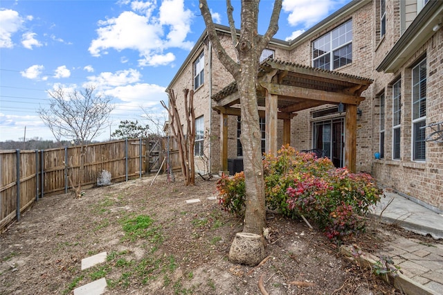 view of yard with a fenced backyard and a pergola