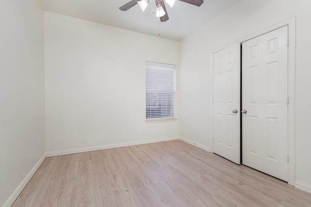 unfurnished bedroom with a ceiling fan, light wood-type flooring, a closet, and baseboards