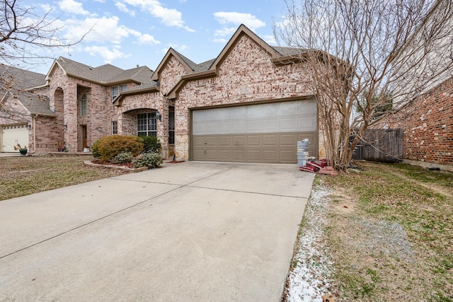 view of front of house with a garage, concrete driveway, brick siding, and a shingled roof