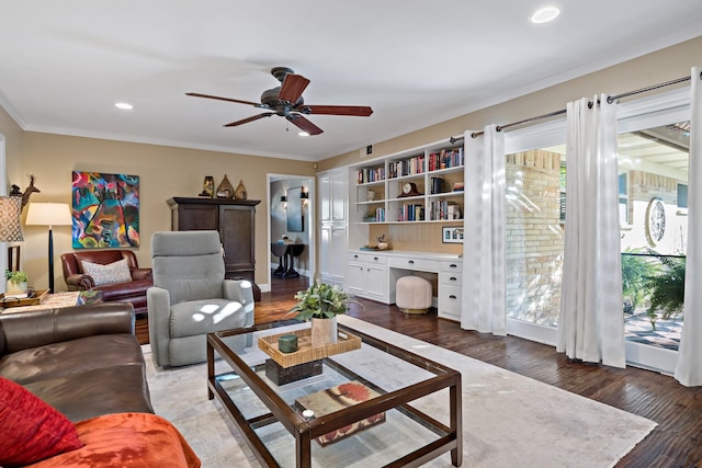 living room with plenty of natural light, crown molding, dark wood-type flooring, and built in study area