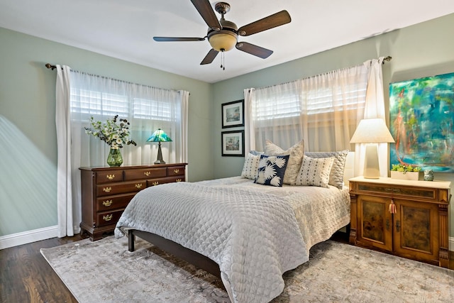 bedroom featuring wood finished floors, a ceiling fan, and baseboards