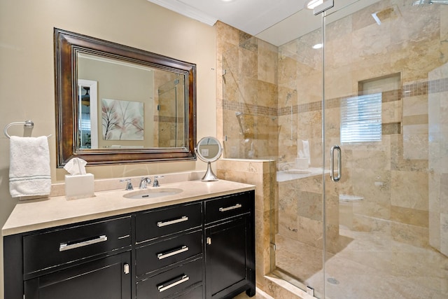 full bath with ornamental molding, a stall shower, and vanity