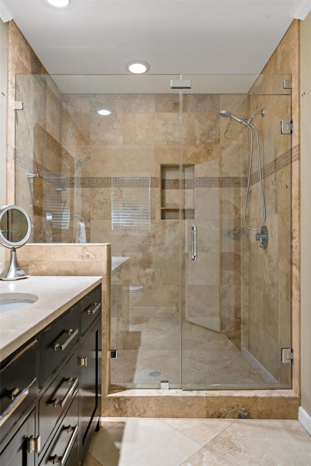 bathroom with a stall shower and vanity