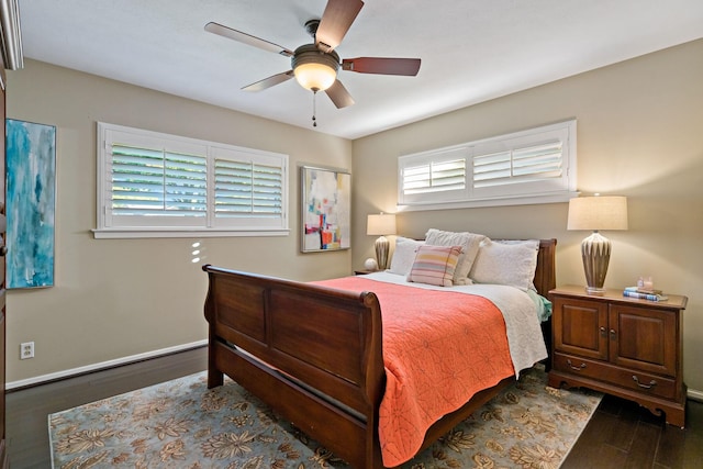 bedroom featuring dark wood-style floors, ceiling fan, and baseboards