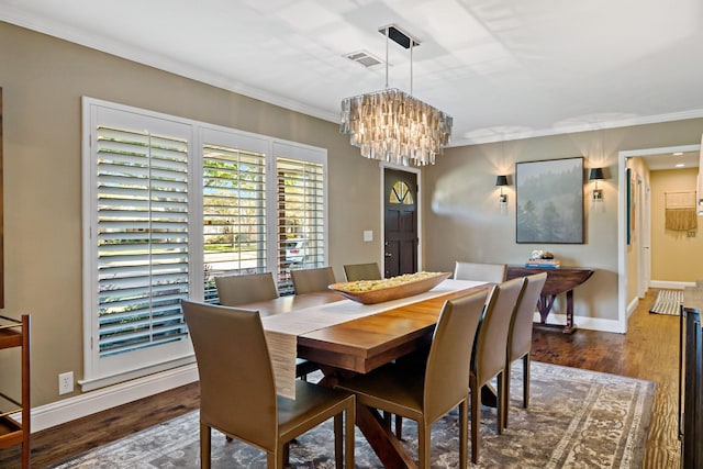 dining area featuring dark wood-style floors, visible vents, crown molding, and baseboards