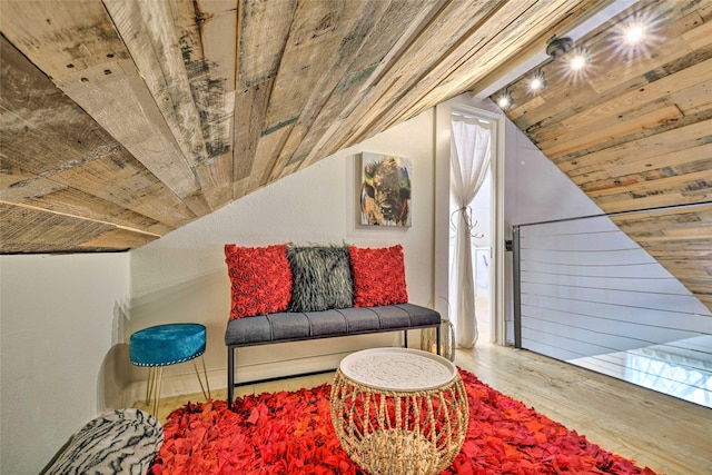 sitting room with lofted ceiling, wood finished floors, and wood ceiling