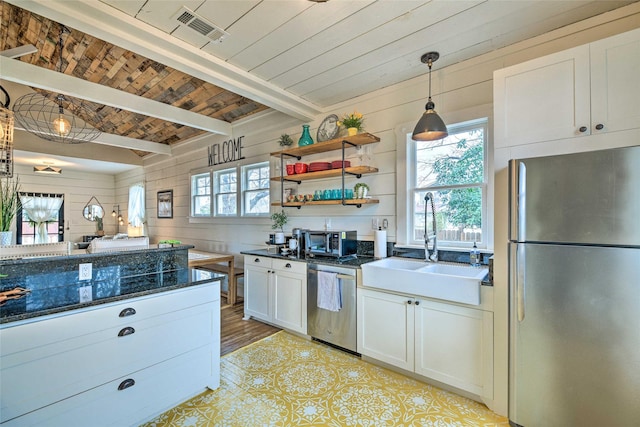 kitchen featuring open shelves, visible vents, appliances with stainless steel finishes, white cabinetry, and a sink