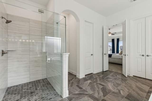 ensuite bathroom with baseboards, ensuite bath, visible vents, and a shower stall