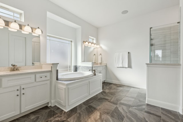 full bath with a garden tub, baseboards, tiled shower, and vanity