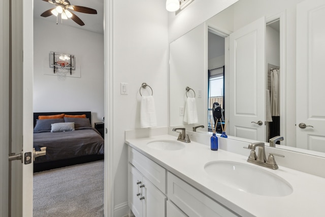 ensuite bathroom featuring a ceiling fan, double vanity, a sink, and ensuite bathroom