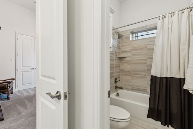 bathroom featuring toilet and shower / bath combo with shower curtain