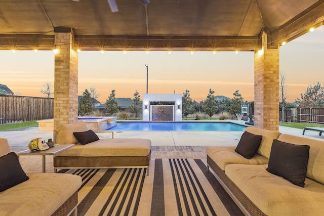 view of pool featuring a fenced backyard, outdoor lounge area, a patio, and a pool with connected hot tub