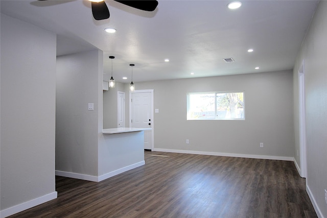 spare room with dark wood-type flooring, recessed lighting, visible vents, and baseboards