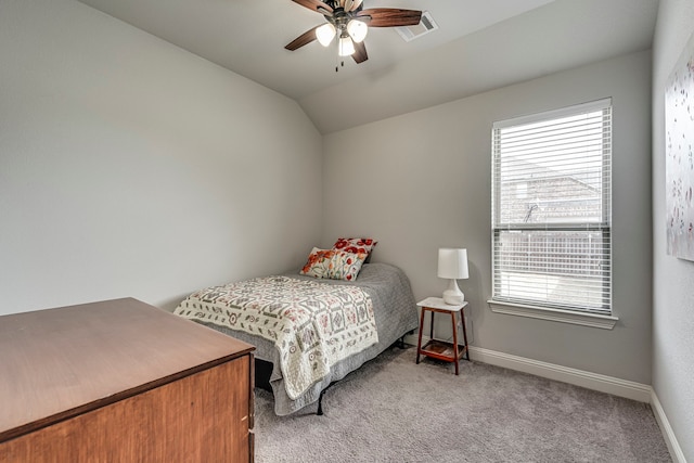 carpeted bedroom with visible vents, vaulted ceiling, baseboards, and ceiling fan