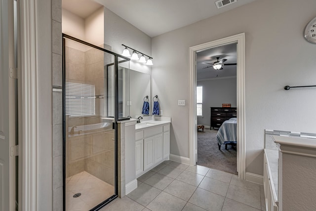 ensuite bathroom with a stall shower, tile patterned floors, vanity, and ensuite bathroom