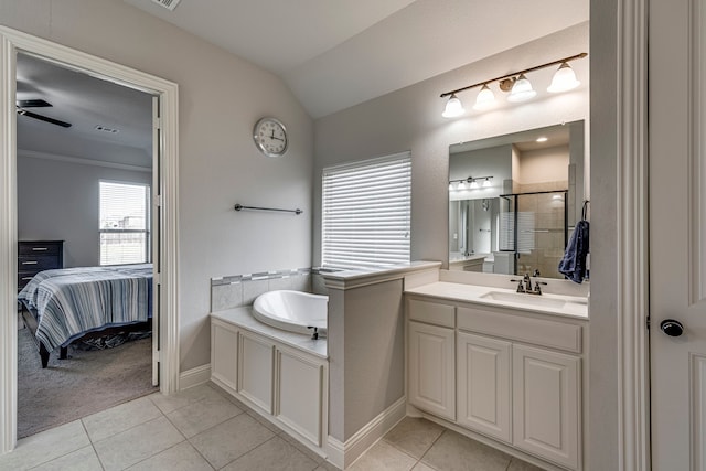 bathroom with lofted ceiling, tile patterned flooring, connected bathroom, vanity, and a shower stall