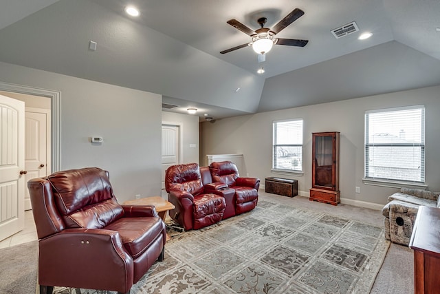 cinema room with light colored carpet, visible vents, vaulted ceiling, and baseboards