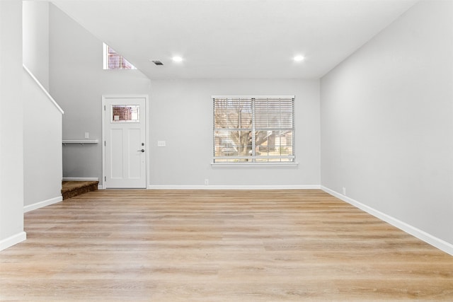 interior space featuring light wood-type flooring, visible vents, baseboards, and recessed lighting