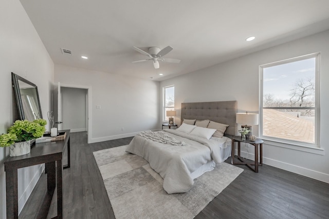 bedroom with recessed lighting, dark wood finished floors, visible vents, and baseboards