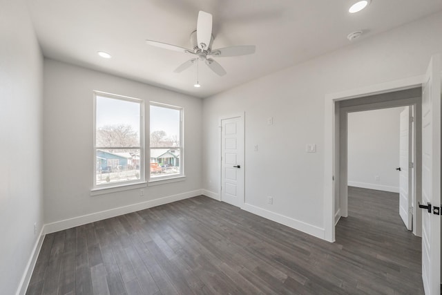 unfurnished room with dark wood-style floors, recessed lighting, a ceiling fan, and baseboards