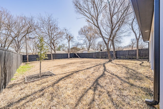 view of yard with a fenced backyard