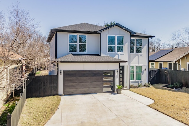 view of front of property featuring a garage, driveway, roof with shingles, and fence