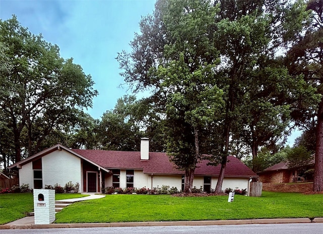 3829 Cloverdale Dr, Tyler, TX 75701 - view of front facade featuring a front yard and a chimney