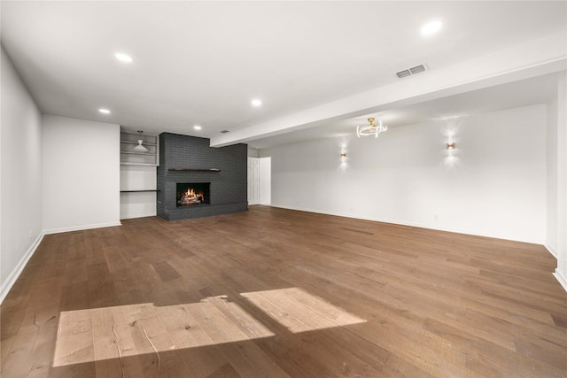 3829 Cloverdale Dr, Tyler, TX 75701 - unfurnished living room with wood finished floors, recessed lighting, a fireplace, and baseboards