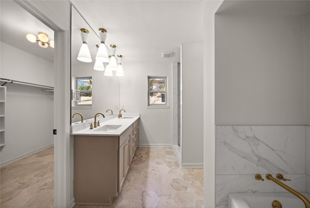 3829 Cloverdale Dr, Tyler, TX 75701 - full bath with a bath, a walk in closet, double vanity, a chandelier, and a shower stall