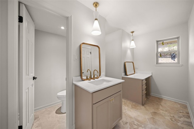 3829 Cloverdale Dr, Tyler, TX 75701 - full bath featuring two vanities, toilet, baseboards, and stone finish flooring