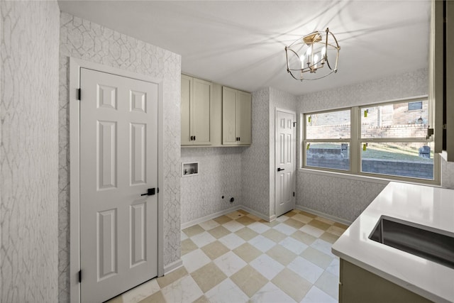 3829 Cloverdale Dr, Tyler, TX 75701 - clothes washing area with hookup for a washing machine, cabinet space, electric dryer hookup, a chandelier, and baseboards