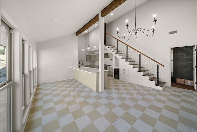 3829 Cloverdale Dr, Tyler, TX 75701 - interior space featuring recessed lighting, a towering ceiling, a chandelier, beam ceiling, and wine cooler