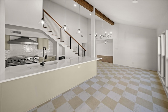 3829 Cloverdale Dr, Tyler, TX 75701 - kitchen featuring wall chimney range hood, range with two ovens, a chandelier, a sink, and beamed ceiling