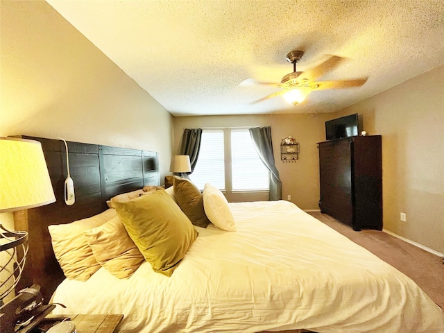 bedroom featuring a textured ceiling, carpet flooring, a ceiling fan, and baseboards