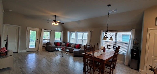 dining area featuring lofted ceiling, baseboards, visible vents, and a ceiling fan