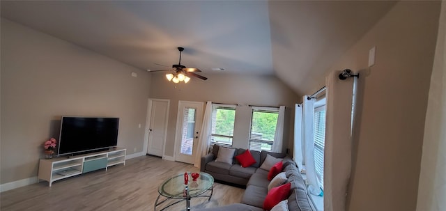 living area with light wood-type flooring, ceiling fan, lofted ceiling, and baseboards