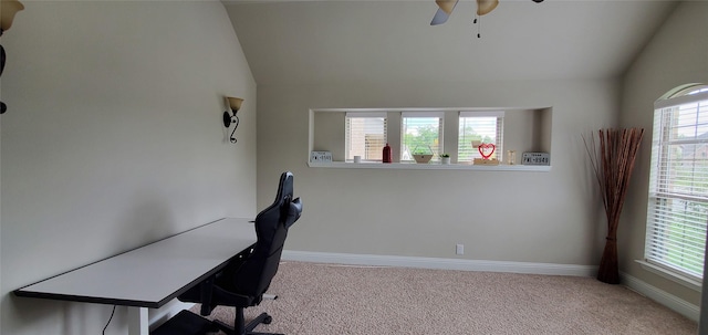 home office featuring baseboards, vaulted ceiling, and light colored carpet