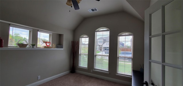 spare room with light carpet, baseboards, visible vents, ceiling fan, and vaulted ceiling