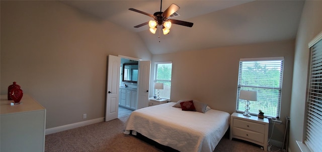 bedroom with light carpet, connected bathroom, vaulted ceiling, ceiling fan, and baseboards