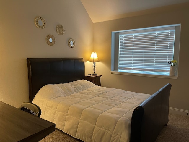 carpeted bedroom featuring vaulted ceiling and baseboards