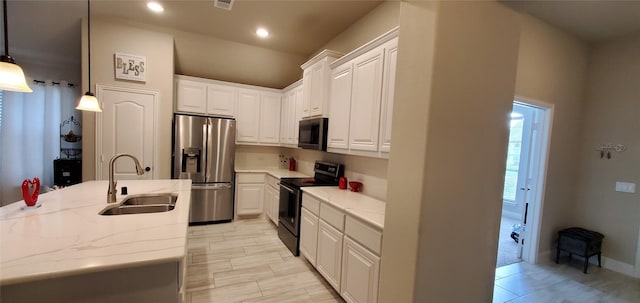 kitchen featuring a sink, stainless steel fridge, white cabinetry, and electric range oven