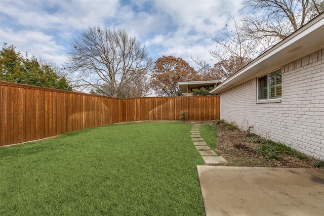 view of yard with a fenced backyard