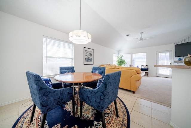 dining space featuring lofted ceiling, visible vents, a ceiling fan, light carpet, and light tile patterned flooring