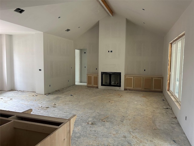 unfurnished living room with visible vents, high vaulted ceiling, beam ceiling, and a glass covered fireplace