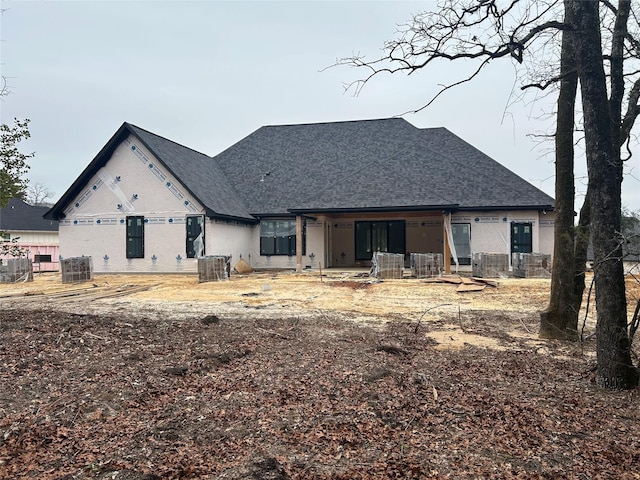 rear view of property featuring central AC unit