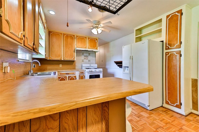 205 Bedford Ct E, Bedford, TX 76022 - kitchen featuring light countertops, a sink, white appliances, decorative backsplash, and a peninsula