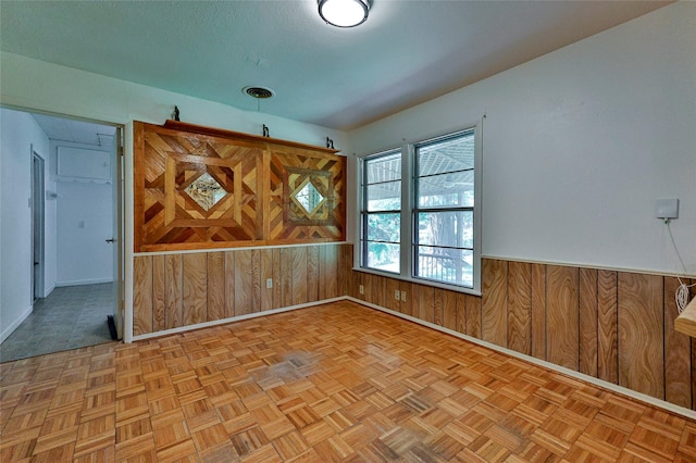 205 Bedford Ct E, Bedford, TX 76022 - unfurnished room featuring visible vents, wood walls, baseboards, and wainscoting