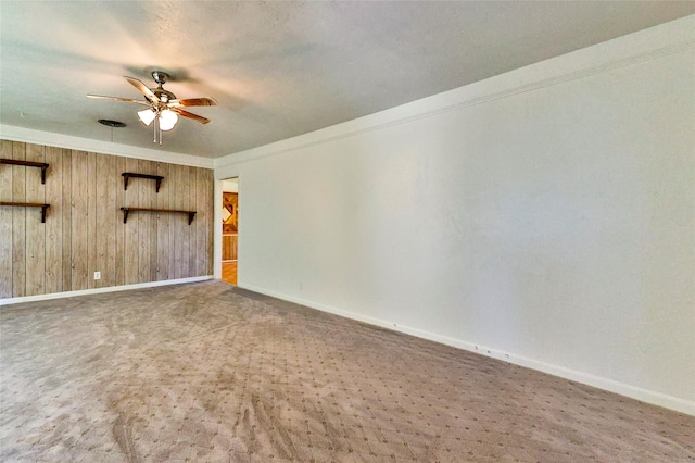 205 Bedford Ct E, Bedford, TX 76022 - unfurnished living room featuring wood walls, ornamental molding, carpet floors, baseboards, and ceiling fan