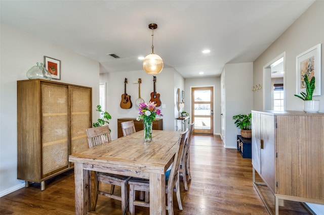 dining area with dark wood-style floors, recessed lighting, visible vents, and baseboards