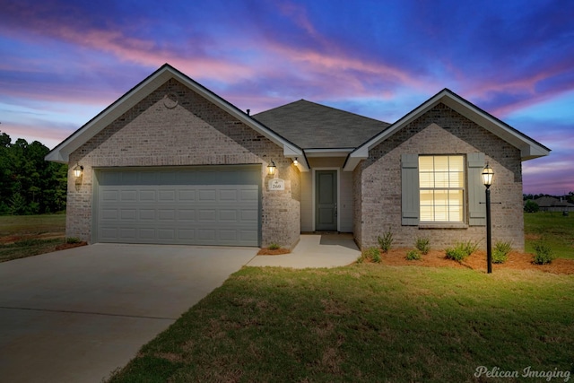 view of front of house featuring concrete driveway, a front lawn, an attached garage, and brick siding